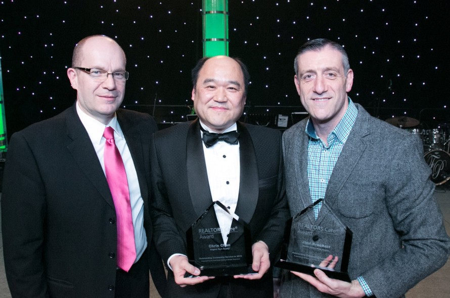 REALTORS® Chris Chan (middle) and Jimi Brockett (right) receive their REALTORS Care® Awards from Real Estate Board of Greater Vancouver president Darcy McLeod