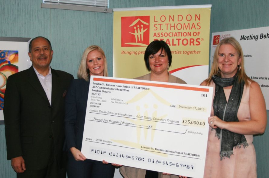 Representatives of LSTAR present a cheque to