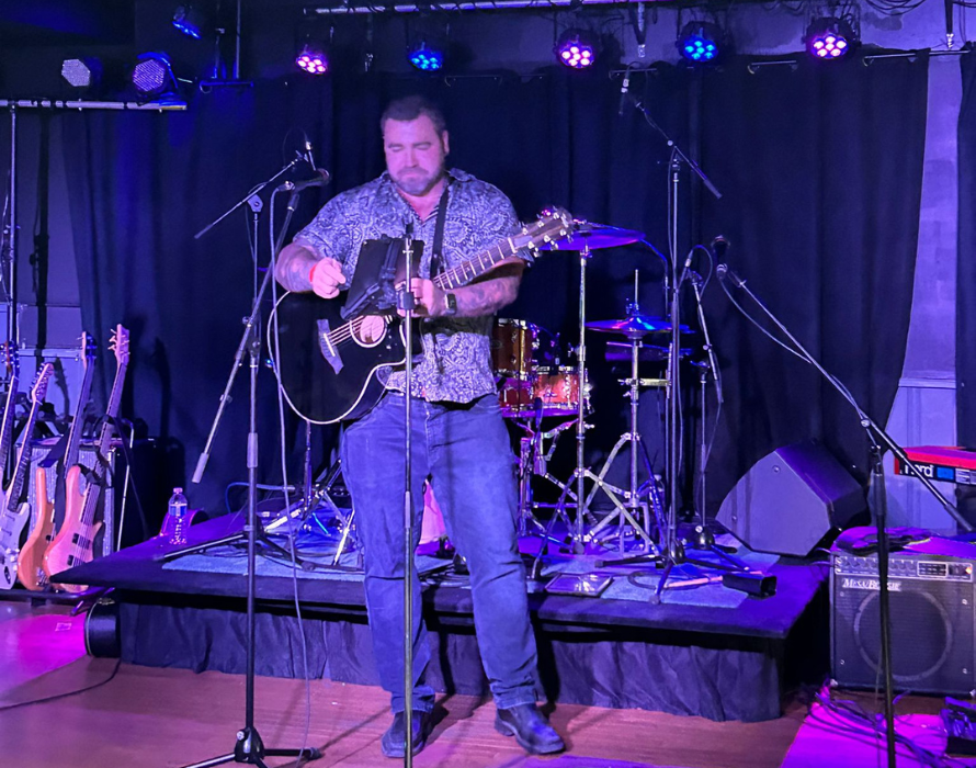 A performer on stage prepares to start his set